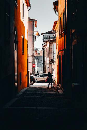 city silhouette of photography of person standing near alley during daytime street