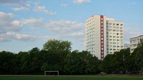 city soccer field near white building at daytime urban