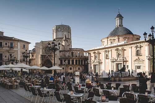 city tables and chairs near building during daytime downtown