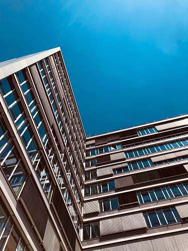 city tall brown concrete building during daytime office building