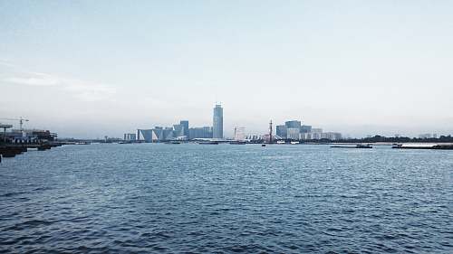 city tall city buildings seen across the harbor town