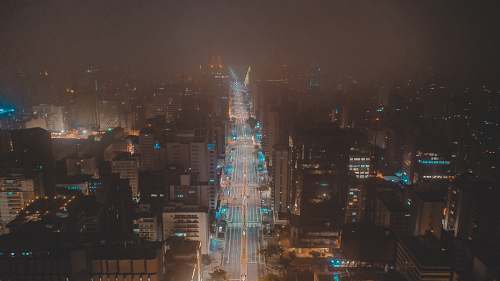 city time lapse photography of road viewing buildings at night time metropolis