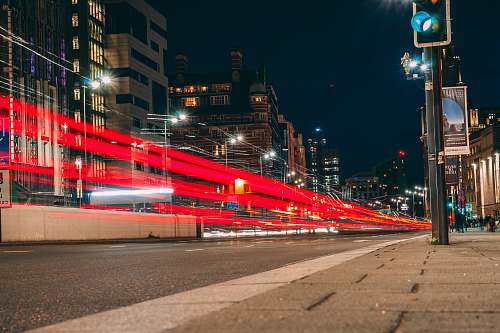 city time-lapse photography of road viewing buildings during night time downtown
