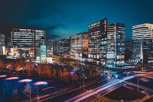 city timelapse photography of city skyline at night downtown