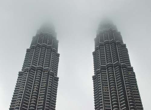 city two gray concrete buildings under white sky high rise