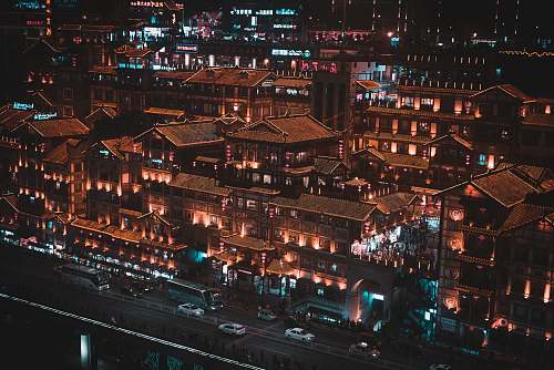 city vehicles on road near buildings at night urban