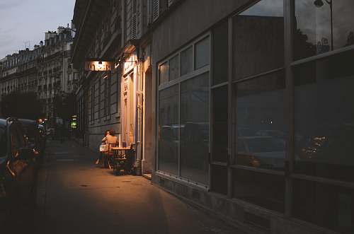 city vehicles parked beside buildings at nighttime road