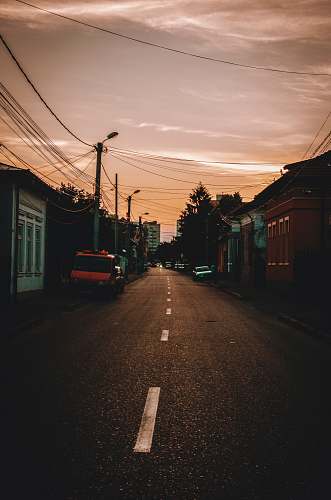 city vehicles parked beside road during sunset street