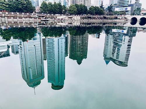 city water mirror reflection of buildings high rise