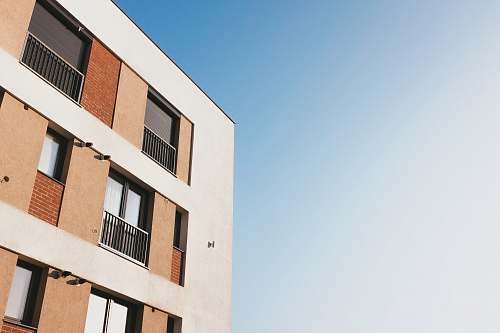 city white and brown concrete building under blue sky during daytime urban