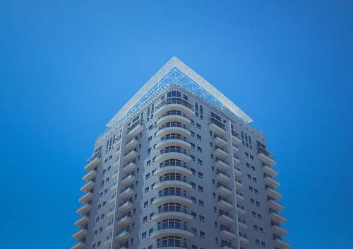 condo white and gray concrete building at daytime housing
