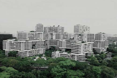 city white building under white sky high rise