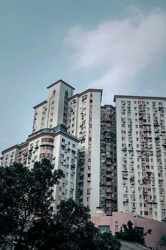 city white concrete building under clear blue sky high rise