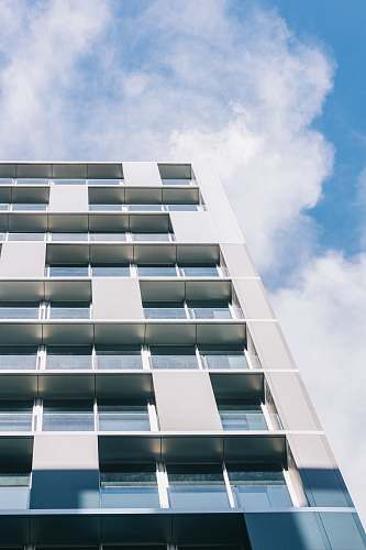 city white high-rise building under white and blue skies high rise