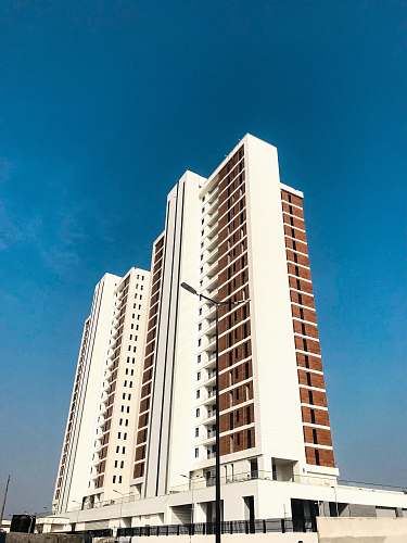 condo white painted high rise building housing