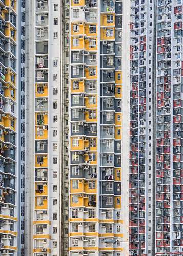 urban white, yellow, and red building high rise