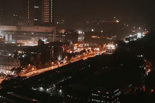 building aerial photo of city buildings at night metropolis
