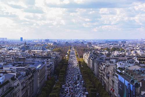 paris aerial photo of city under white clouds arc de triomphe