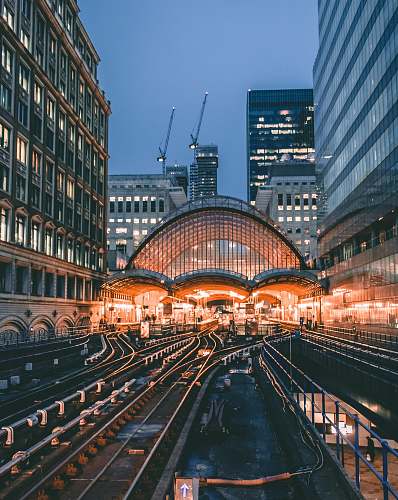building aerial photo of train railway surrounded by buildings metropolis