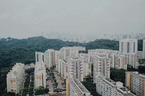building aerial photography of buildings under white skty high rise
