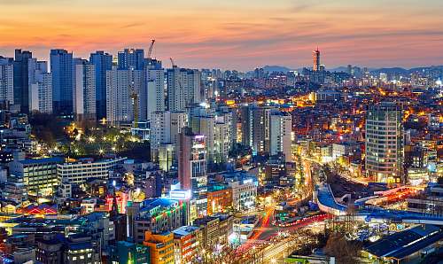 building aerial photography of lighted city high rise buildings during dawn town