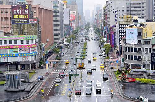road aerial photography of vehicles at road beside building intersection