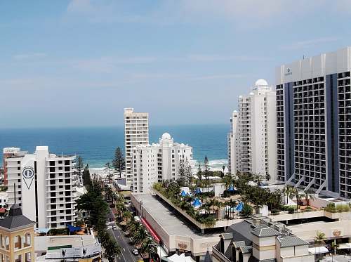 building aerial view of city buildings across body of water high rise