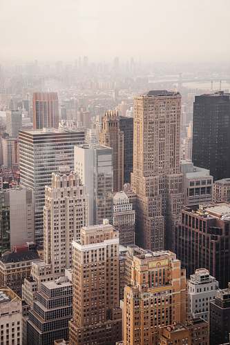 building aerial view of city under cloudy sky during day time architecture