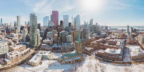 building aerial view of city under white clouds town