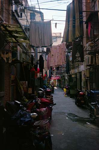 building assorted clothes hung on wire between buildings road