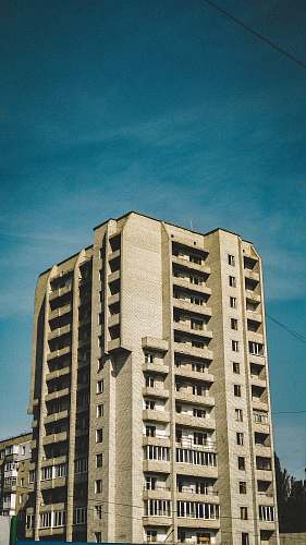 building beige concrete high-rise building during daytime high rise