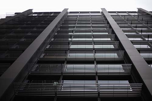 building black tall concrete building during daytime high rise