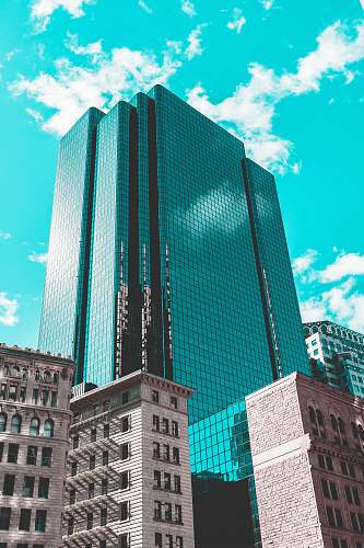 building blue curtain wall building under teal skies architecture