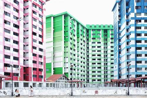 urban blue, pink, and green high-rise buildings town