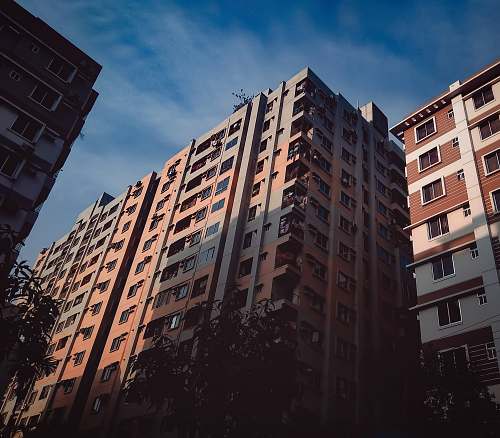 town brown and beige concrete building during daytime high rise
