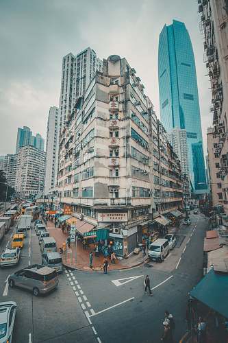 building cars and people walking on road road