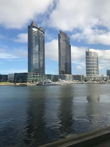building city and sea during day high rise