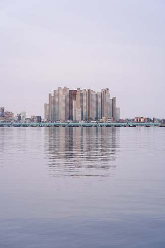 building cityscape near the calm body of water during daytime high rise