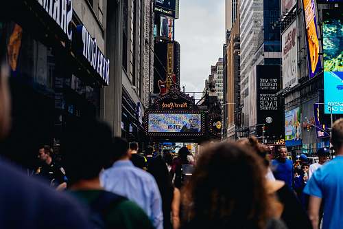 building crown people walking beside sidewalk metropolis