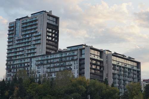 building gray high-rise building under white sky high rise