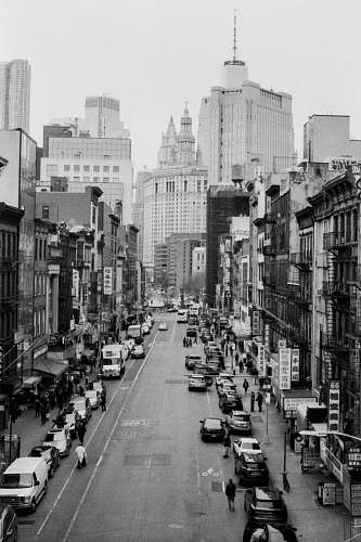 building grayscale photo of street across buildings black-and-white