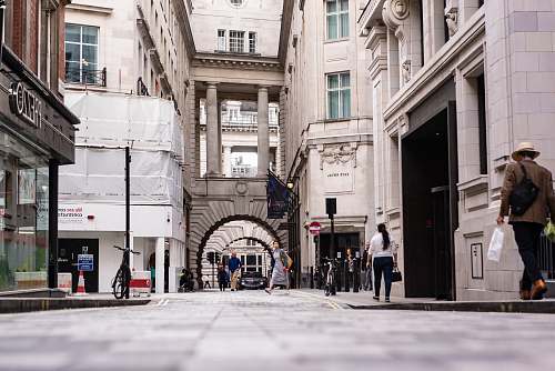 town grayscale photography of people walking on street urban