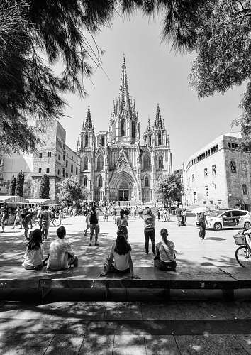 building graysclae photo of people facing church black-and-white