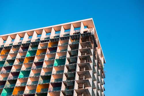 building green and beige painted building urban