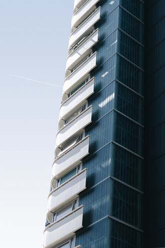 building grey and white curtain building during daytime urban