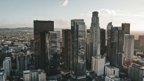 building high rise buildings in city under white louds urban