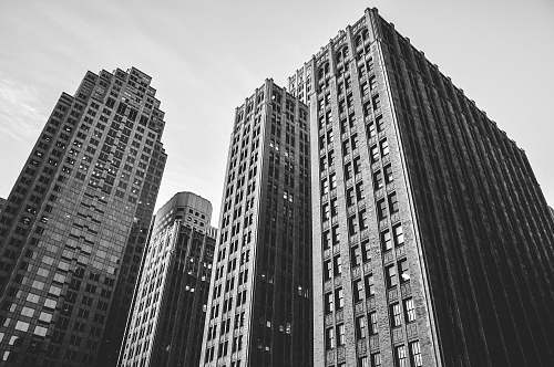 architecture low angle grayscale photography of high-rise buildings black-and-white