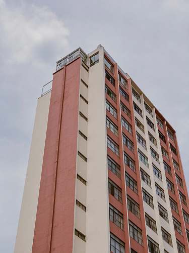 building low-angle photo of orange and white striped building high rise