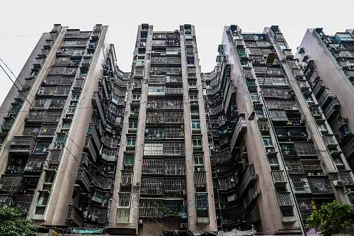 building low-angle photography of black and gray concrete high-rise building high rise