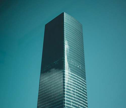 building low-angle photography of blue glass high-rise building high rise